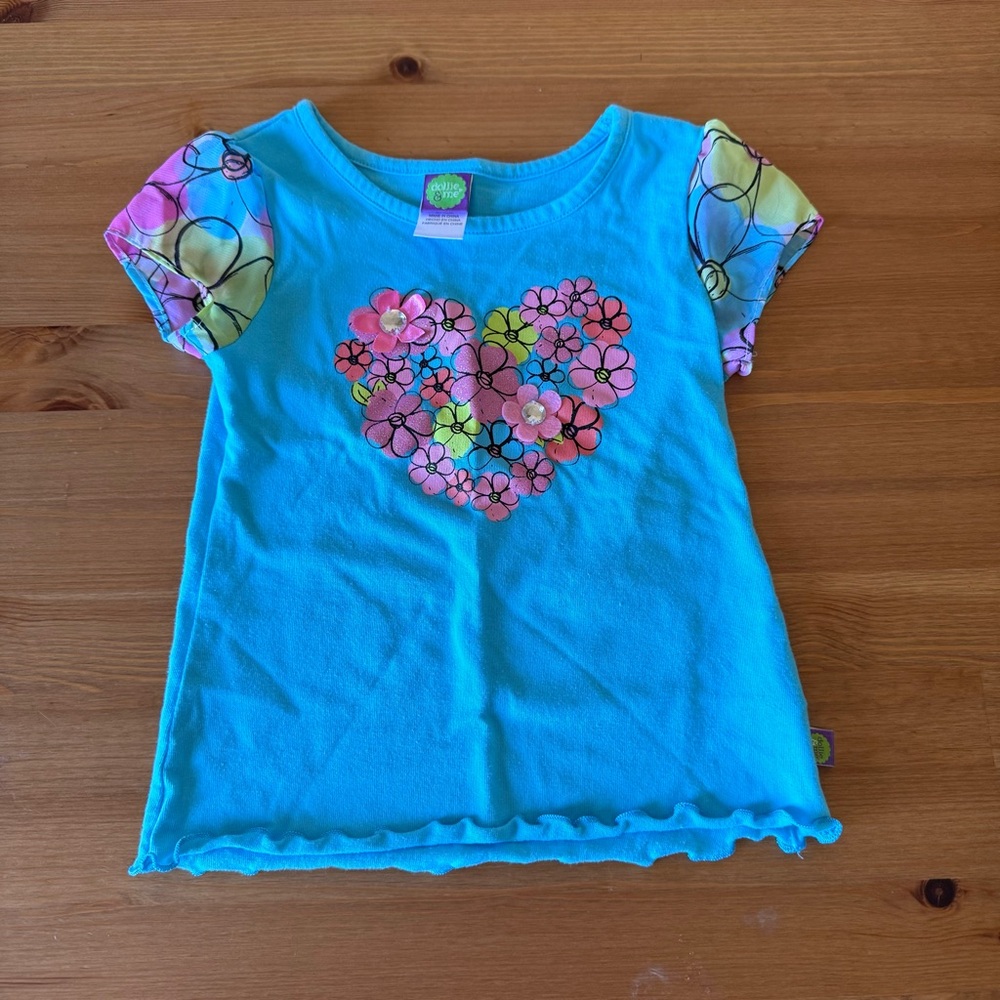 Blue and pink baby tee with a heart design by Dollie And Me